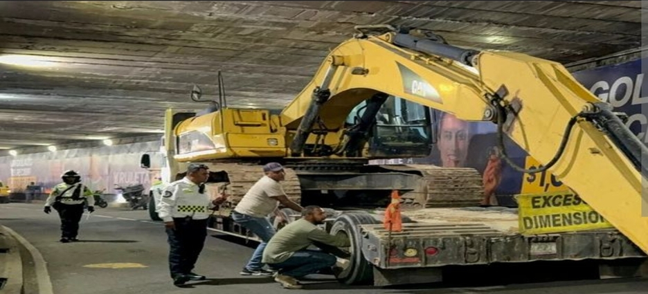 Tráiler con maquinaria pesada queda atorado en bajopuente de Chapultepec